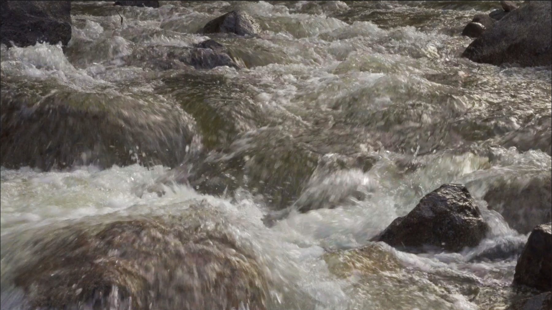 Decorative background of water rushing over rocks
